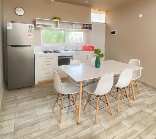 a kitchen with a table and chairs and a refrigerator at Ribera Del Norte in Canoas