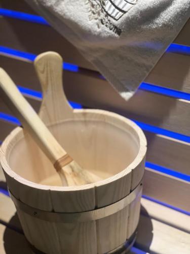 a wooden cup with a wooden spoon in it at Lux studio sa saunom Ampelitsi in Ledine
