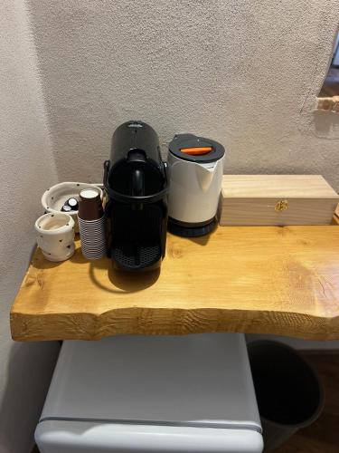 a coffee maker sitting on top of a wooden table at La Cascina di Bea in Torre Boldone