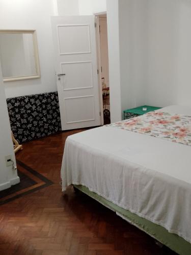 里约热内卢Apartamento com 187m2 três quartos, quadra da praia de Copacabana.的卧室配有白色的床和门