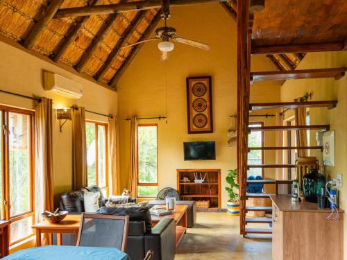 a living room with a couch and a table at Impala Cottage in Hoedspruit