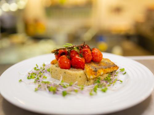 a white plate with a piece of bread with strawberries on it at Oravský Háj Garden Hotel & Resort in Trstená