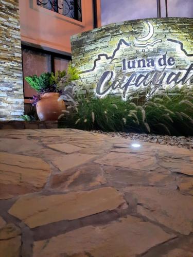 a sign on the side of a building with plants at Luna de Cafayate Hotel Boutique in Cafayate