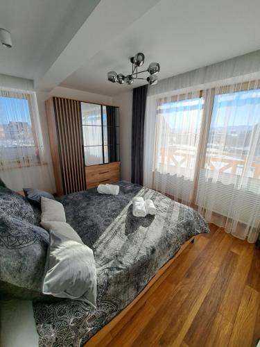 a bedroom with a large bed with two towels on it at Apartament Kluskowe Widoki in Kluszkowce