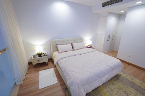 a bedroom with a large bed in a room at Luxury Apartment by the Sea with Amazing Amenities at Pearl Qatar in Doha