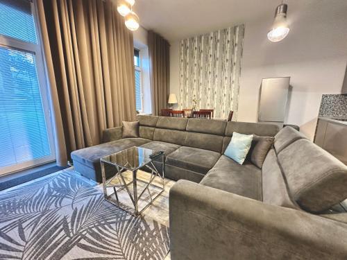 a living room with a couch and a table at Royal City Centre Apartment in Poprad