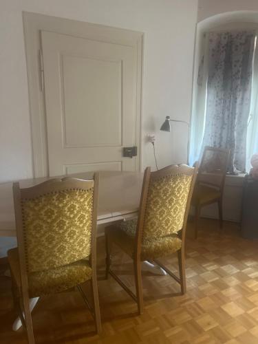 a dining room with a table and two chairs at Central old town room with private kitchen in Biel