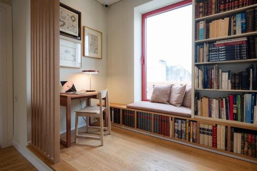 a room with a desk and a window with bookshelves at NINE DOTS Azorean Art Boutique Hotel in Ponta Delgada
