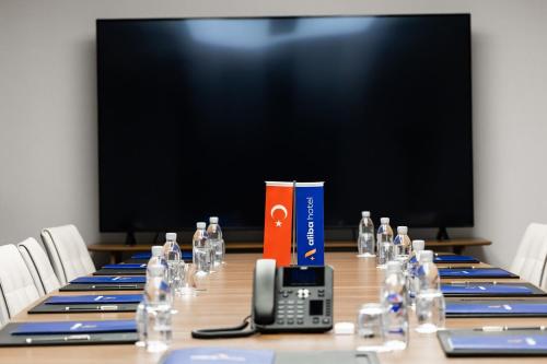 a conference table with a cell phone and a box on it at ALİBA HOTEL in Edirne