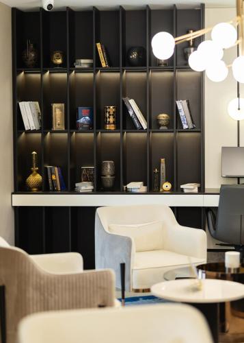 a room with chairs and a shelf with books at ALİBA HOTEL in Edirne