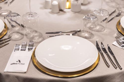 a table with a white plate and silverware on it at ALİBA HOTEL in Edirne