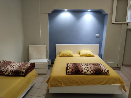 1 dormitorio con 2 camas y pared azul en Hotel Marhaba - Beb Bhar Tunis en Túnez