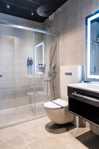 a bathroom with a shower and a toilet and a sink at ALİBA HOTEL in Edirne