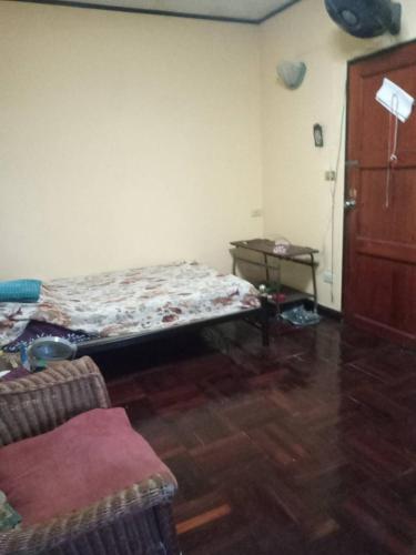 a room with a bed in the corner of a room at NP Prime FREE WiFi in Bangkok