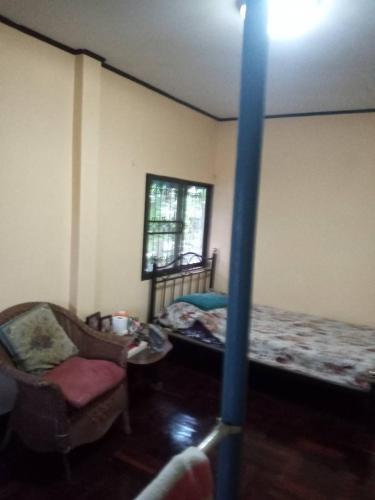 a room with a bed and a couch and a chair at NP Prime FREE WiFi in Bangkok