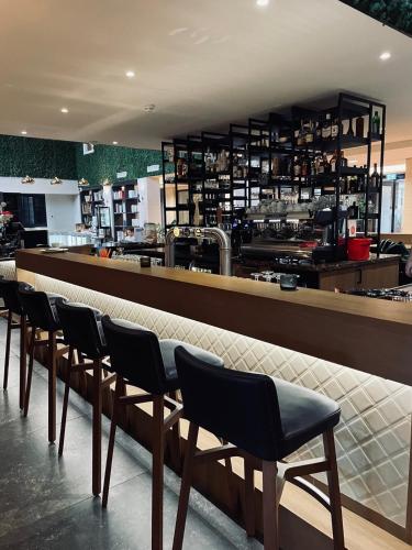 a row of chairs sitting at a bar in a restaurant at Woonlandschap De Leyhoeve Groningen in Groningen