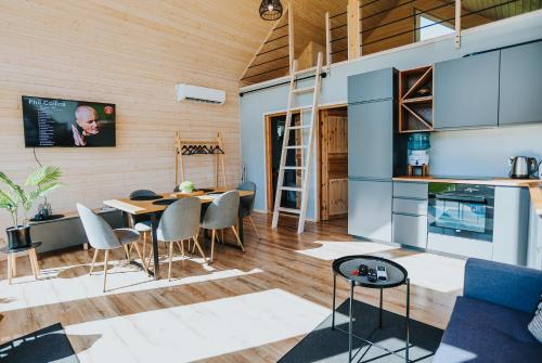a kitchen and living room with a table and chairs at Seashore Holiday House in Saraiķi