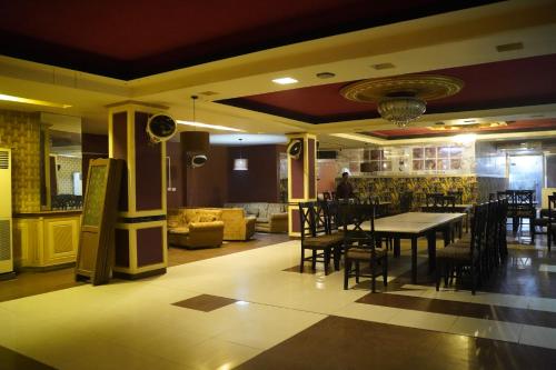 a dining room with a table and chairs at HOTEL TOURIST INN in Lahore