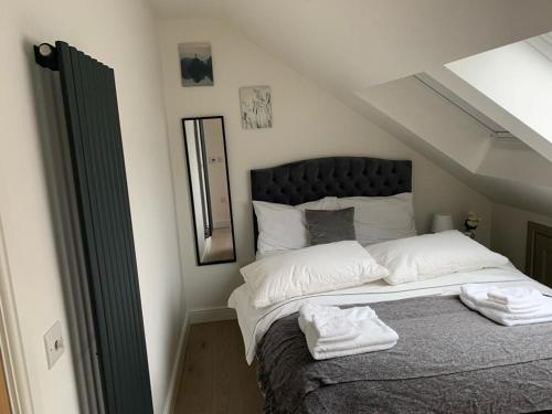 a bedroom with a bed with two towels on it at One Bedroom Apartment London in London