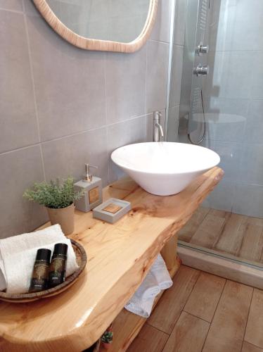 a bathroom with a white sink and a mirror at Archontiko tis Irinis in Ádhele