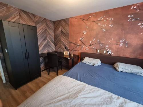 a bedroom with two beds and a wall with a painting at 500-Mb Hi-Tech Silent Work-Home in Amsterdam