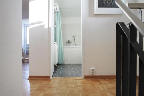 a bathroom with a shower and a bath tub at reoh I Maisonette am See I Malerischer Ausblick I Beamer I Berlin in 30min in Strausberg