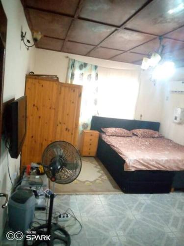 a bedroom with a bed and a fan in it at 2 bedroom Bungalow @ St John in Mount Aureol