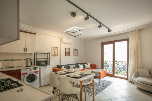 a kitchen and a living room with a table at flaneur home in Marmaris