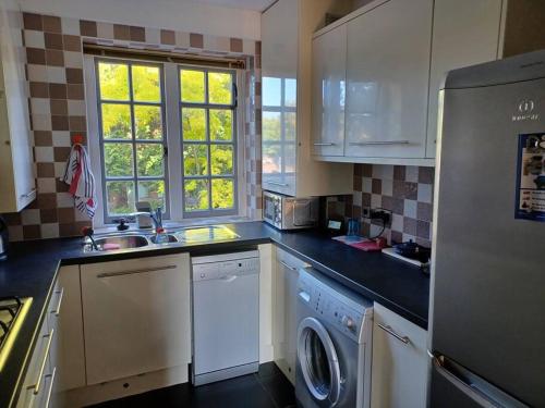 a kitchen with a sink and a dishwasher at The Gem - central character flat with parking in Southampton