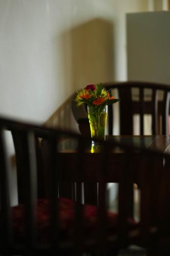 a vase of flowers sitting on top of a table at Elephant Trail in Udawalawe