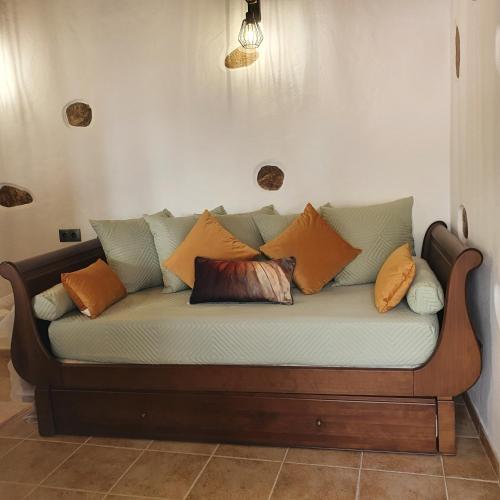 a couch with many pillows on it in a room at La Gallania de Papá Pepe in Santa Lucía