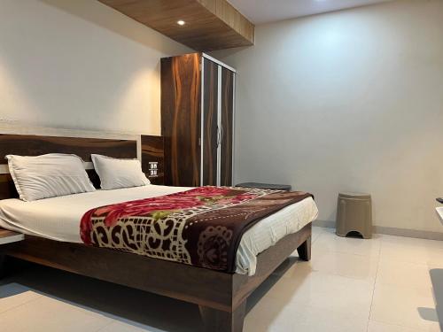 a bedroom with a large bed in a room at C P Hotel in Mahabaleshwar