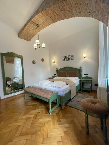 a bedroom with two beds and a mirror at Casa Lais in Braşov