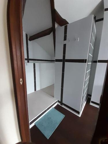 an empty room with a glass door and a staircase at Belle maison du 18e siècle in Bazemont