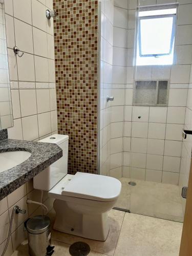 a bathroom with a toilet and a sink and a shower at Sapphire Tower CTC 601-B in Caldas Novas