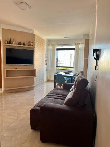 a living room with a couch and a flat screen tv at Sapphire Tower CTC 601-B in Caldas Novas