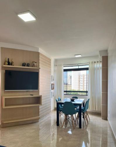 a dining room with a table and a television at Sapphire Tower CTC 601-B in Caldas Novas