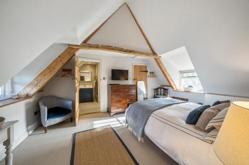 a bedroom with a large bed in a attic at Barton Cottage Bed and Breakfast in Broadmayne