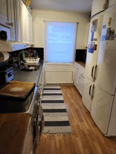 eine Küche mit einem weißen Kühlschrank und einem Fenster in der Unterkunft Room At The Backyard In A Family House & Room Inside A Family House 