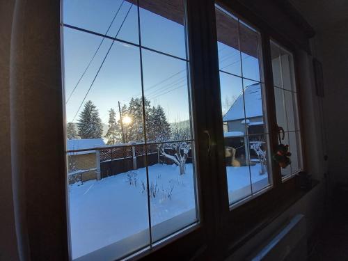 a window with a view of a snow covered yard at Vikendica Paša in Pale