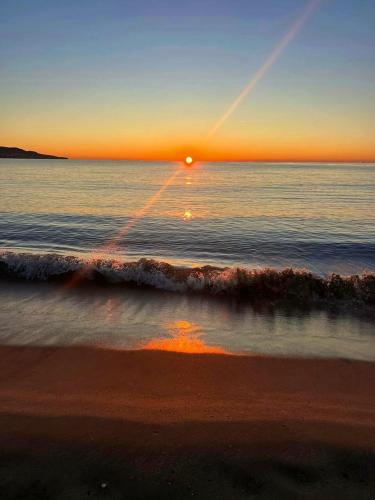 a sunset over the ocean with the sun reflecting in the water at Modern studio by the lake in Empuriabrava - 30m² - Superb view in Empuriabrava