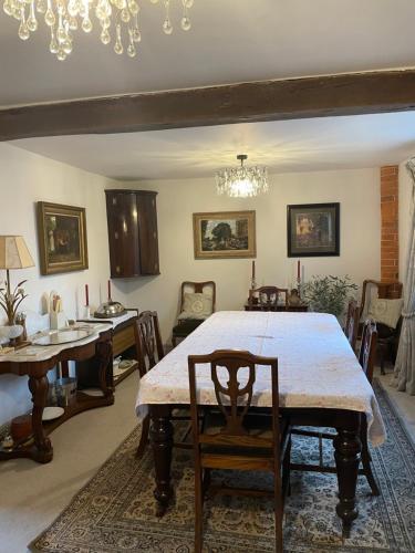 a dining room with a large table and chairs at Joyce’s Barn 