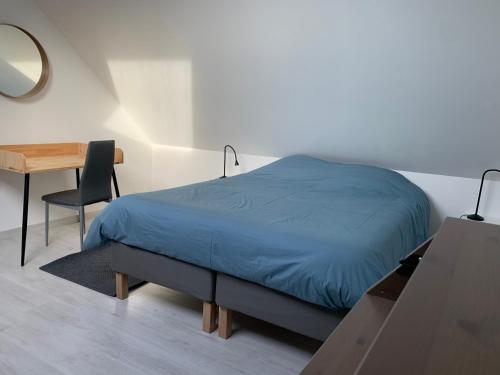 een slaapkamer met een bed, een bureau en een spiegel bij Loft au calme, idéal pour famille, proche de Reims in Saint-Brice-et-Courcelles
