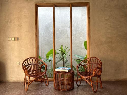 two chairs and a table in front of a window at Be Zanzibar Boutique Hotel in Mfumbwi
