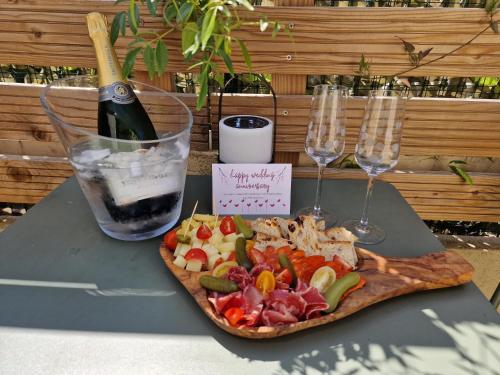 a plate of food with a bottle of wine and glasses at Le Mas de Mougins in Mougins