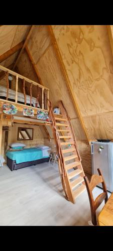 a room with two bunk beds in a attic at Refugio de bosque altos de ñancul in Panguipulli