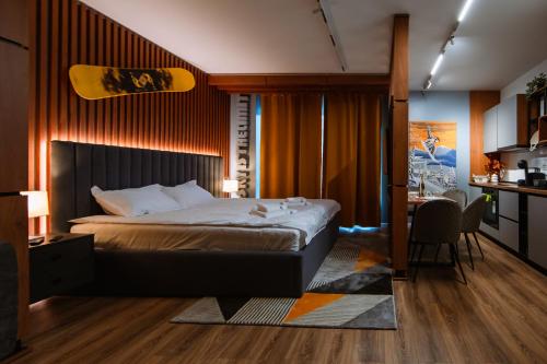 a bedroom with a bed and a desk and a table at Blue Sky Studio with pool and spa in Sinaia