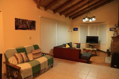 a living room with a bed and a couch at VALLE GRANDE - CASA ARAUCARIA - SOLAR DEL VALLE in Valle Grande