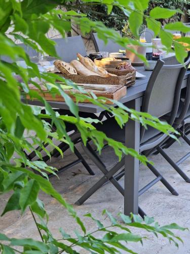 a picnic table with bread and baskets of food at Le Mas de Mougins in Mougins