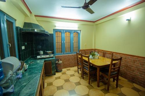 a kitchen with a table and chairs in a room at Paradise Boutique Hotel in Pokhara